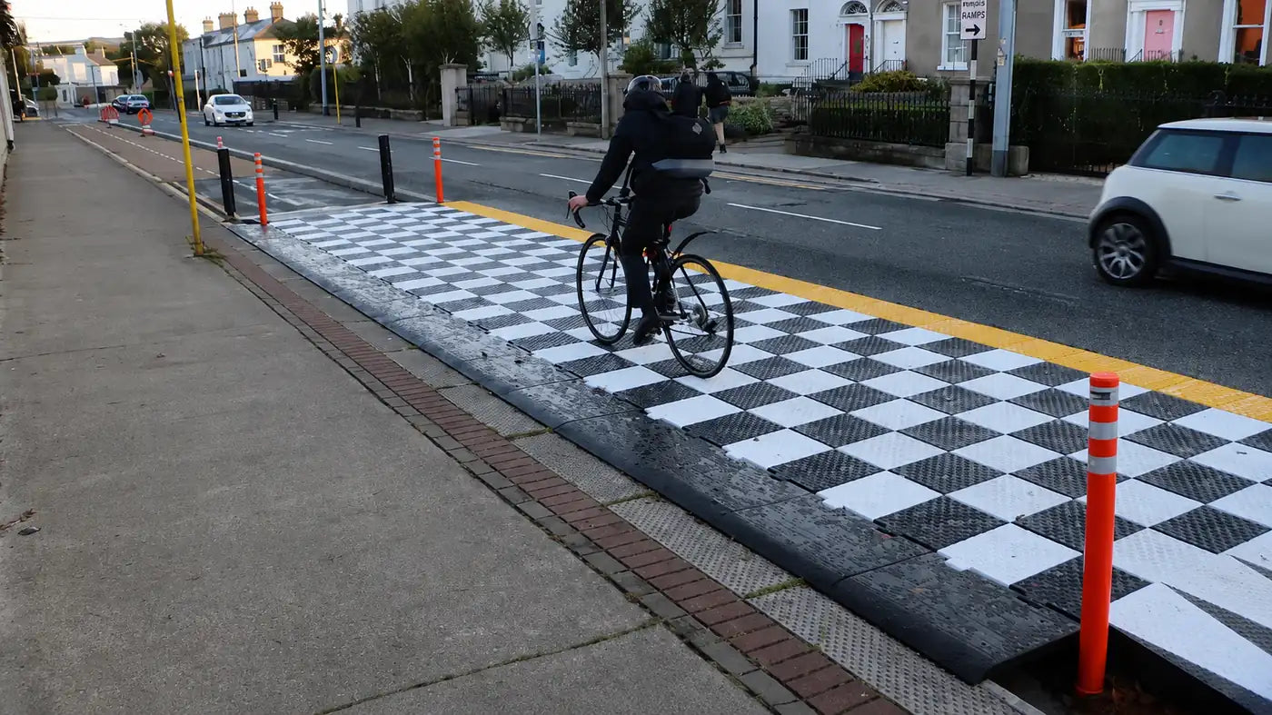 Cyclist using protected cycle lane infrastructure in an urban environment