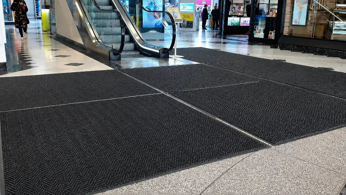 Entrance matting installed in a shopping centre to reduce dirt and moisture