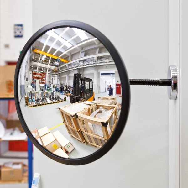 Mirror mounted to wall in warehouse