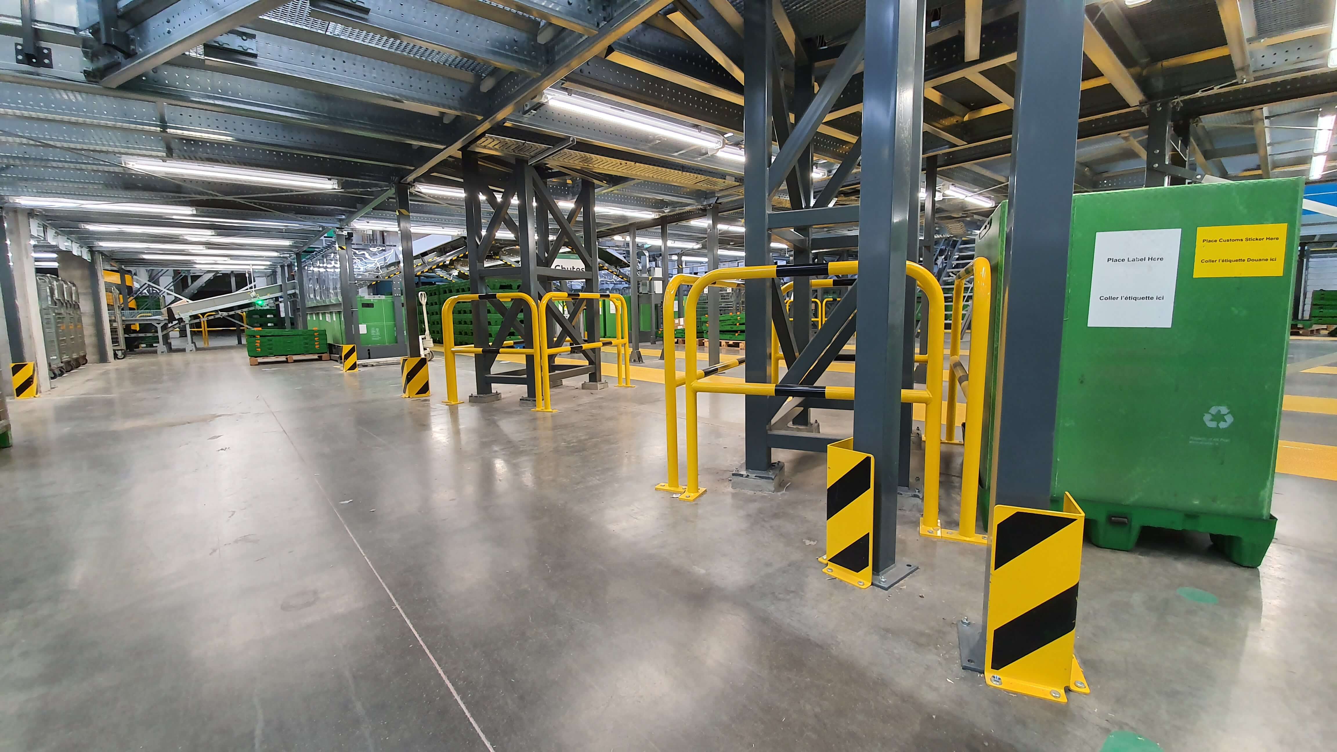 Steel hoop guards protecting columns in warehouse