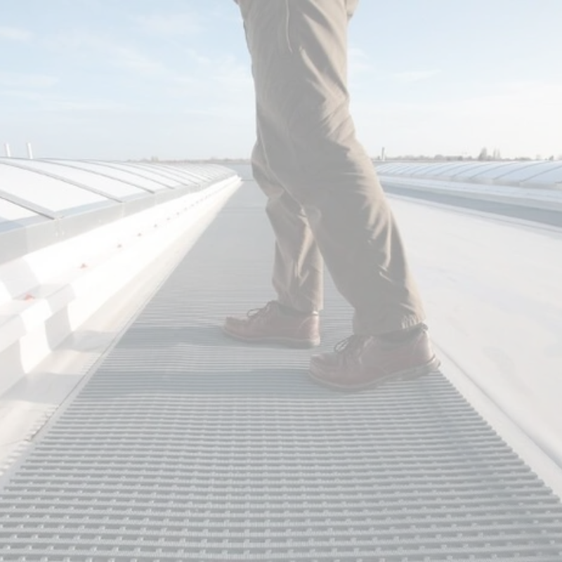 Person walking on a roof with safety matting 